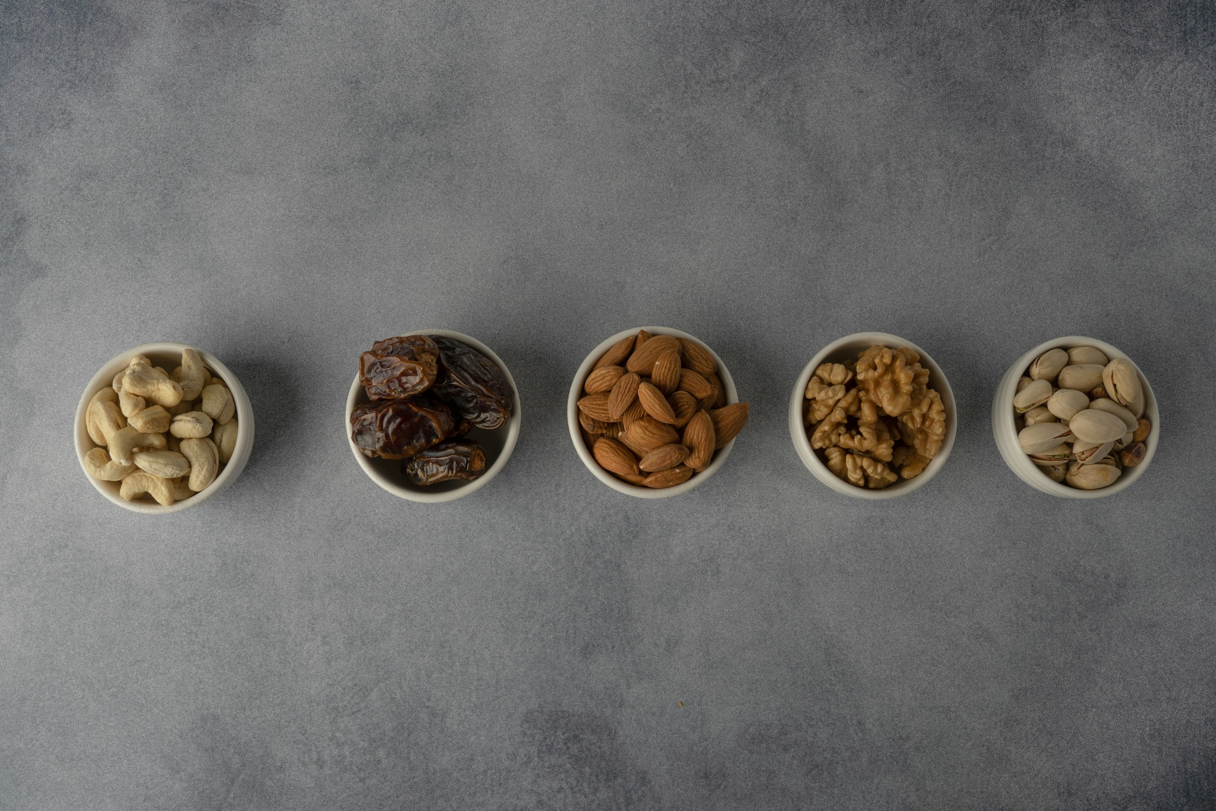 Assorted wholesale nuts and dried fruits in bowls